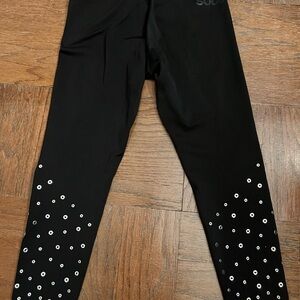 SoulCycle black leggings with silver grommets